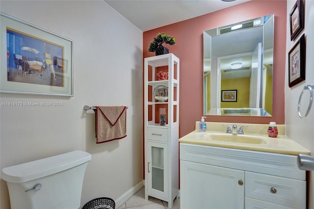 bathroom featuring tile patterned floors, vanity, and toilet