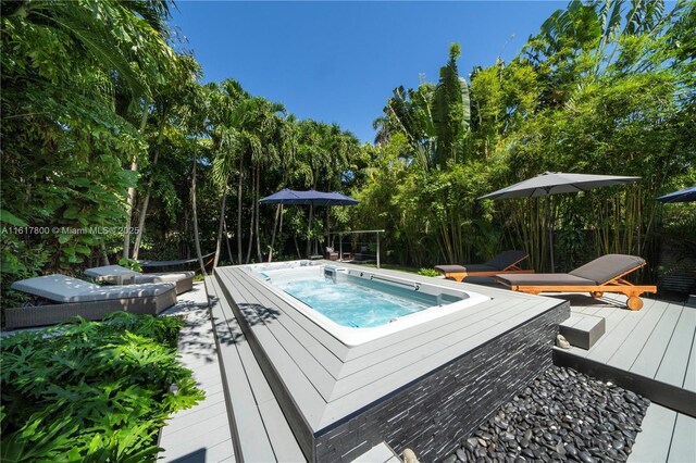 view of swimming pool featuring a deck