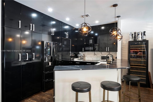 kitchen featuring black appliances, a breakfast bar, backsplash, and pendant lighting