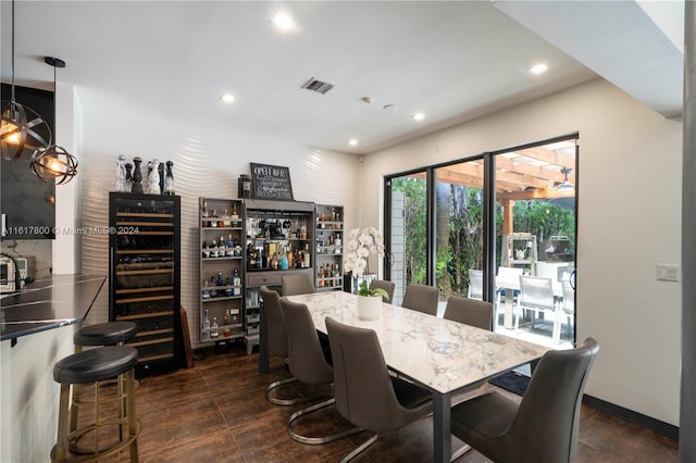 dining space with bar area and wine cooler