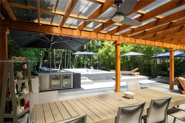 wooden deck with ceiling fan and a pergola