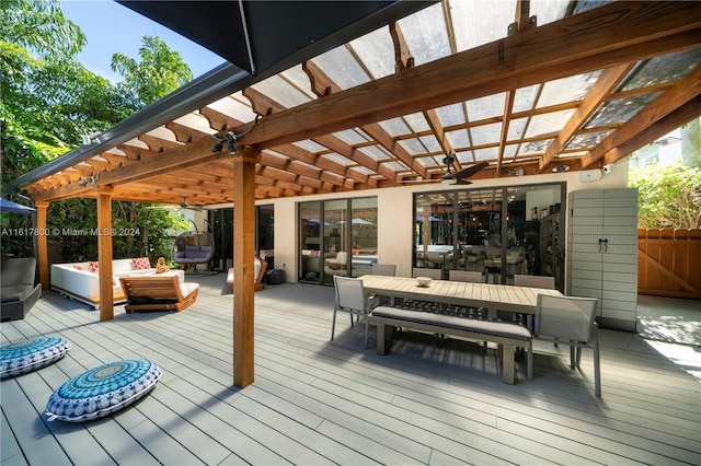 wooden deck featuring a pergola and an outdoor hangout area