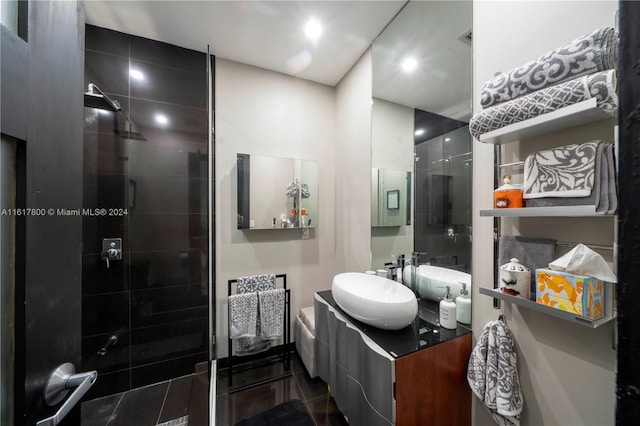 bathroom with a shower with door and vanity