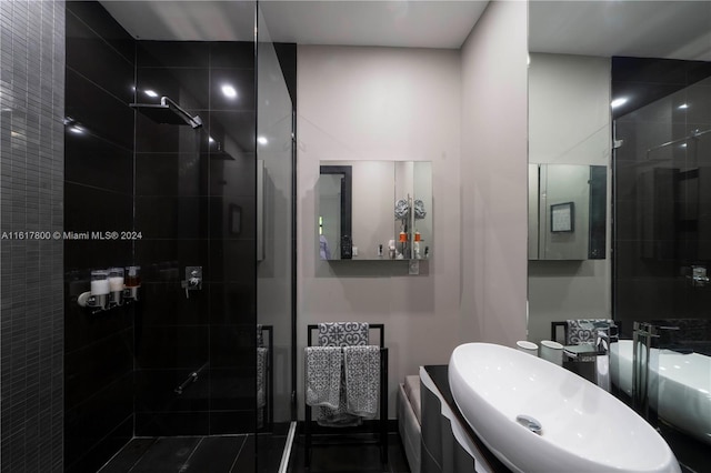 bathroom featuring vanity and tiled shower