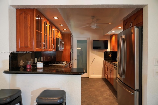 kitchen featuring appliances with stainless steel finishes, a breakfast bar area, and kitchen peninsula