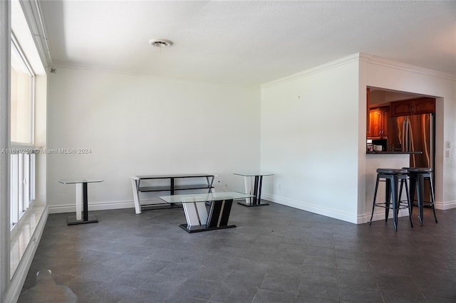 dining space featuring crown molding