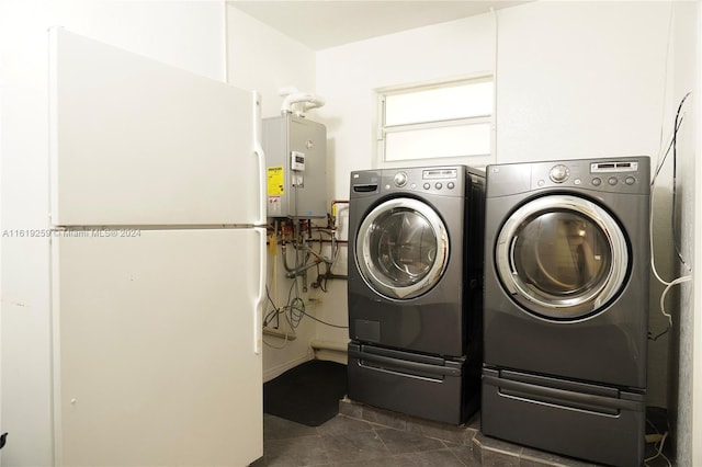 laundry room with independent washer and dryer and tankless water heater