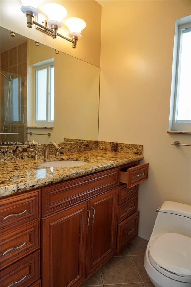 bathroom with walk in shower, tile patterned floors, toilet, and vanity