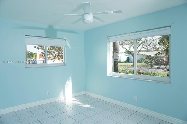 spare room featuring light tile patterned floors and ceiling fan