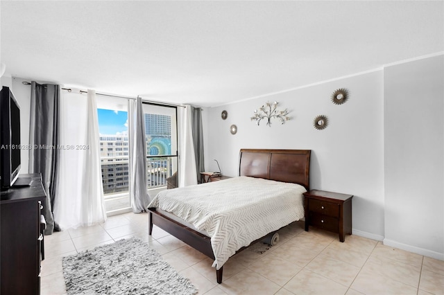 tiled bedroom featuring access to outside and expansive windows