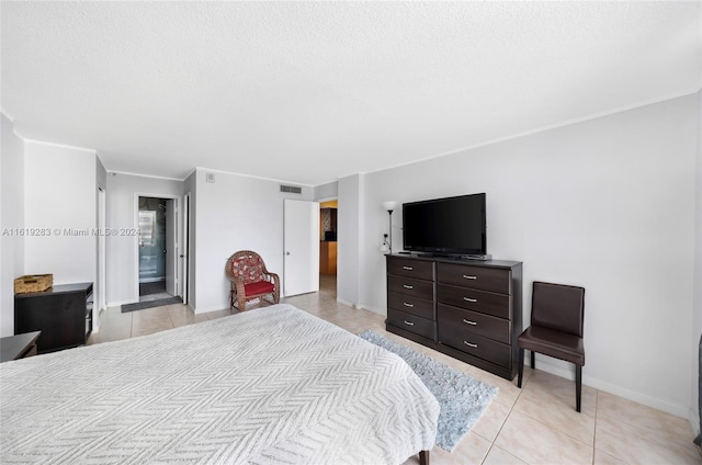 tiled bedroom with ornamental molding and ensuite bathroom