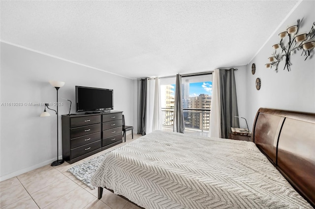 bedroom with light tile patterned flooring, access to exterior, and a textured ceiling