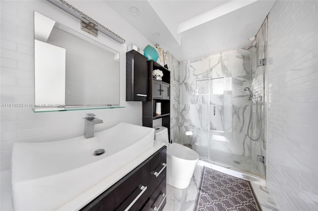 bathroom with tile patterned floors, a shower with shower door, vanity, and tile walls