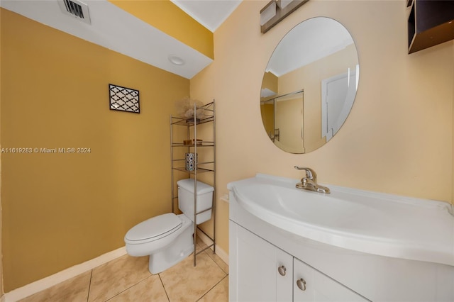 bathroom featuring tile patterned floors, vanity, and toilet