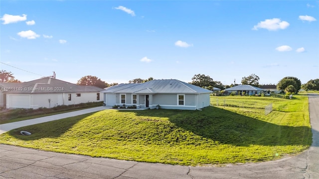 single story home featuring a garage and a front lawn