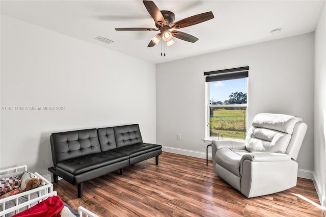 living area with ceiling fan and hardwood / wood-style flooring