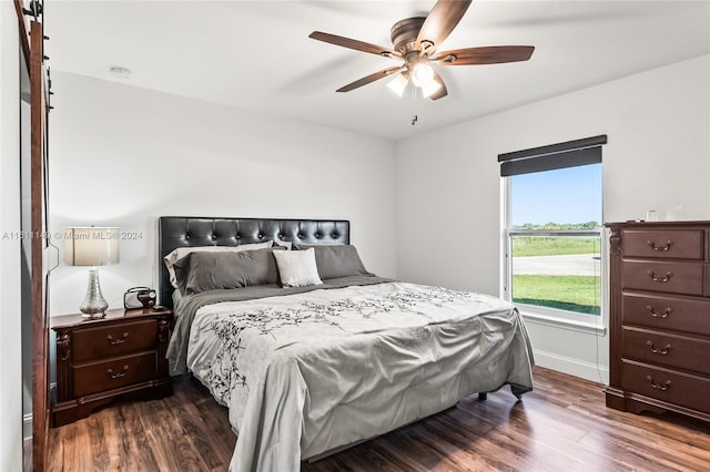 bedroom with ceiling fan and dark wood-type flooring