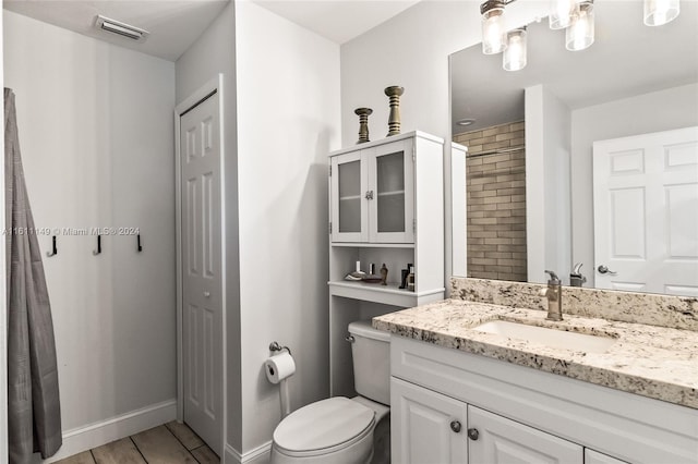 bathroom with toilet and vanity