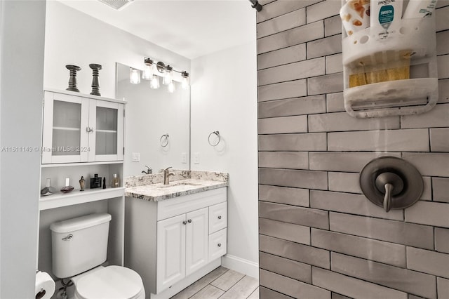 bathroom with vanity, wood-type flooring, and toilet