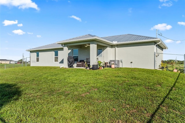 rear view of house with a patio and a yard