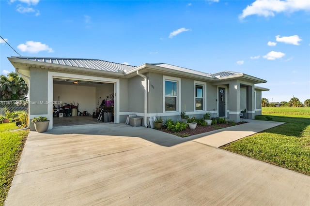 view of front of house featuring a garage and a front lawn