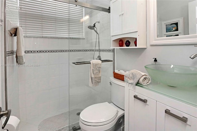 bathroom with walk in shower, vanity, and toilet