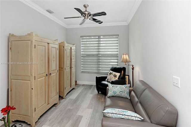 sitting room featuring light hardwood / wood-style floors, ceiling fan, and crown molding