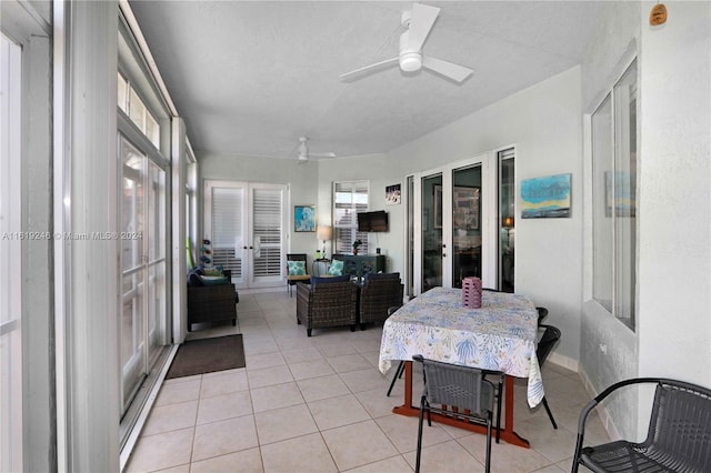 sunroom / solarium featuring ceiling fan and french doors