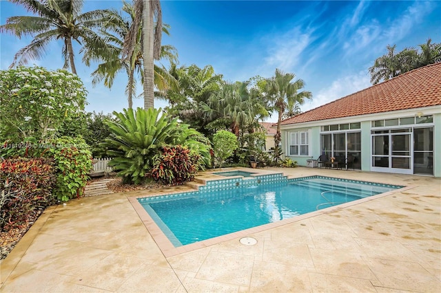 view of swimming pool with an in ground hot tub and a patio area