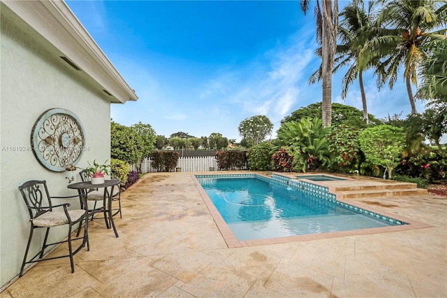 view of pool featuring an in ground hot tub and a patio area