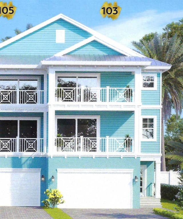 view of front facade featuring a garage and a balcony