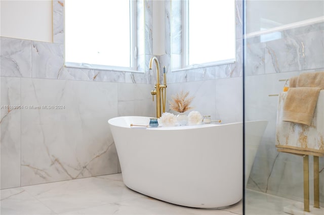 bathroom with a tub to relax in