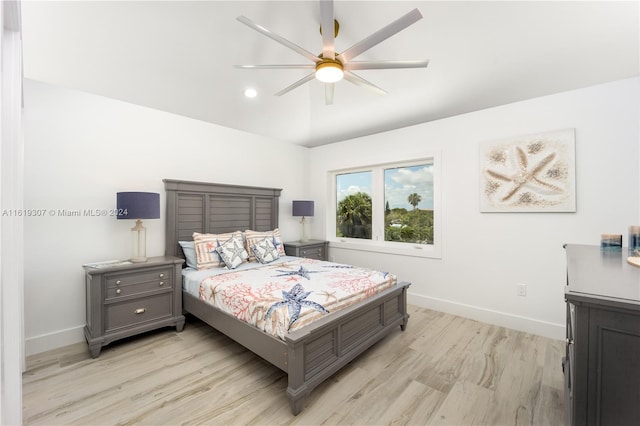 bedroom featuring lofted ceiling, ceiling fan, and light wood-type flooring