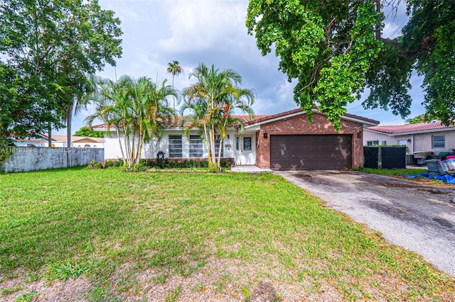 single story home featuring a garage and a front yard