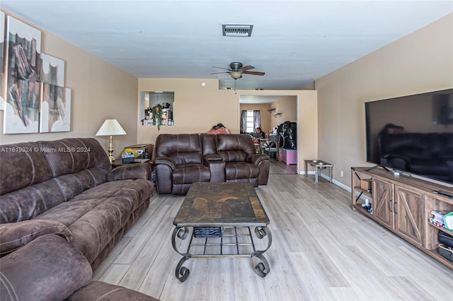 living room featuring light wood-type flooring and ceiling fan