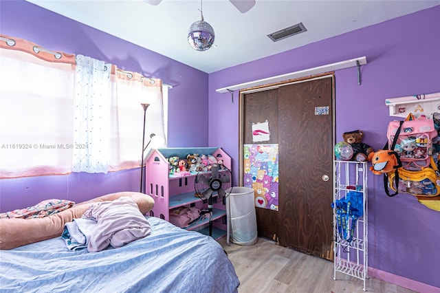 bedroom featuring hardwood / wood-style flooring and ceiling fan