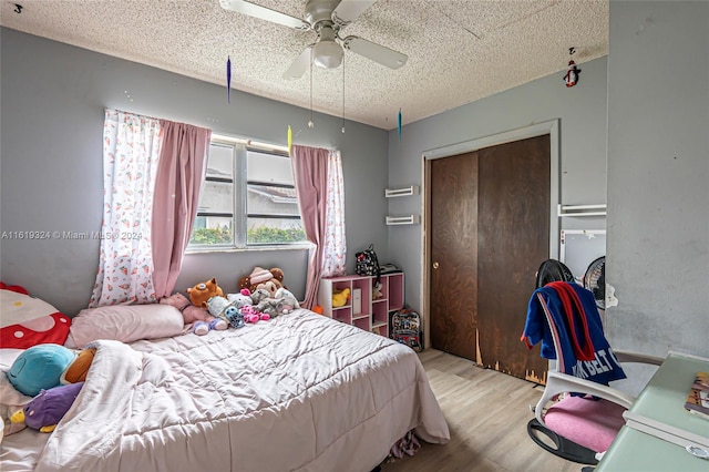 3991 NW 108th Ave, Coral Springs, FL 33065 - bedroom with wood finished floors, a textured ceiling, a closet, and ceiling fan