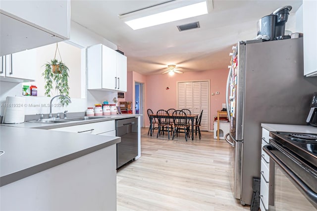 3991 NW 108th Ave, Coral Springs, FL 33065 - kitchen featuring appliances with stainless steel finishes, a sink, white cabinets, and light wood-style floors