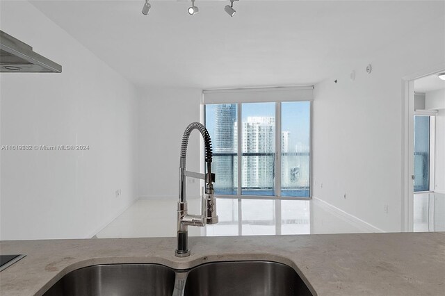 kitchen with sink, rail lighting, and floor to ceiling windows