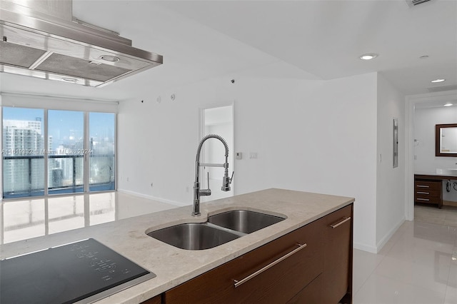 kitchen with light tile patterned flooring, black electric cooktop, dark brown cabinetry, and sink