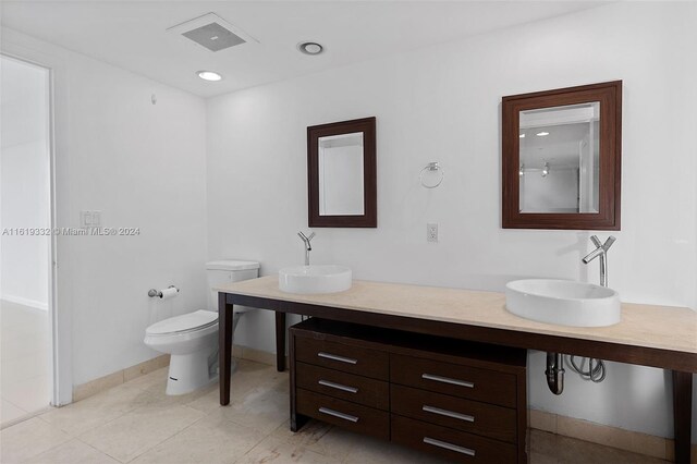 bathroom featuring tile patterned floors, toilet, and vanity