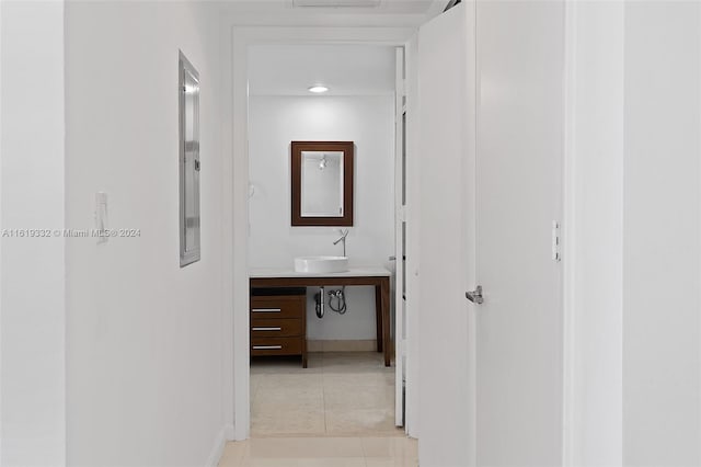 hall with sink and light tile patterned floors