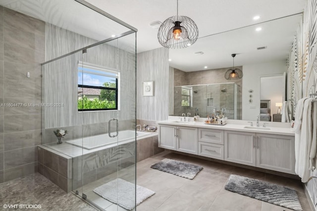 bathroom featuring tile patterned floors, plus walk in shower, and vanity