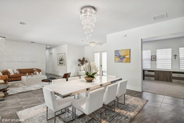 tiled dining space with a notable chandelier