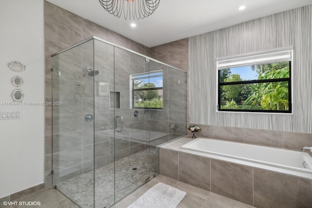 bathroom with tile patterned flooring and independent shower and bath