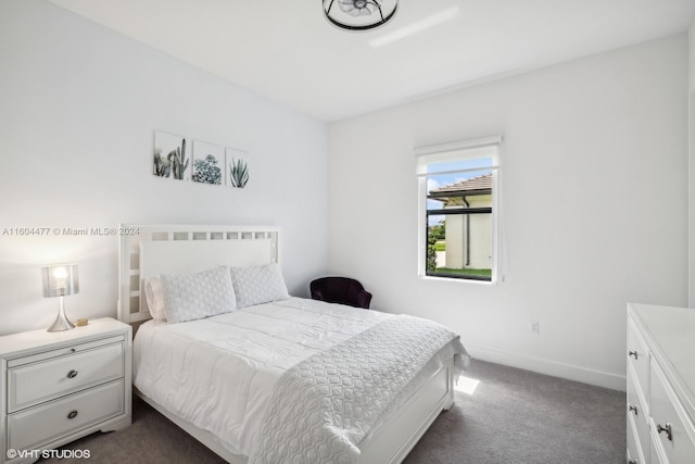 bedroom featuring dark carpet