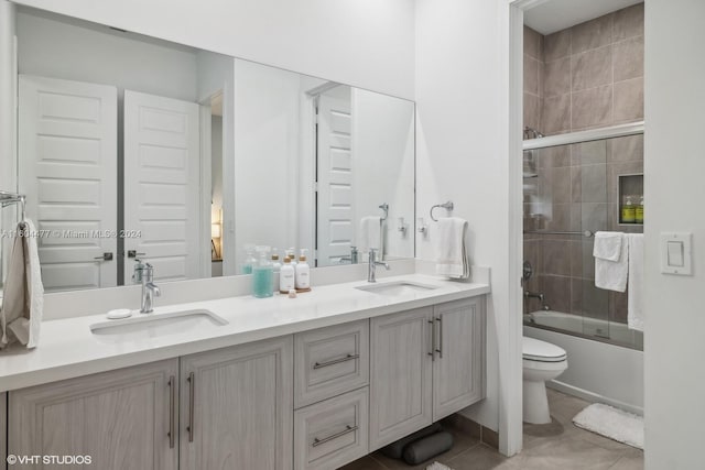 full bathroom featuring tile patterned flooring, vanity, bath / shower combo with glass door, and toilet