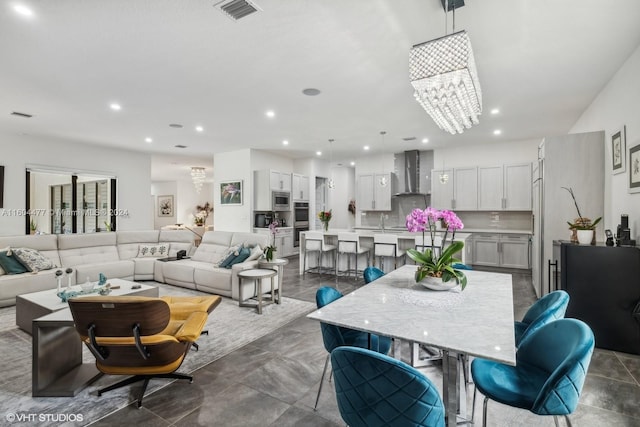 dining space featuring a notable chandelier and sink