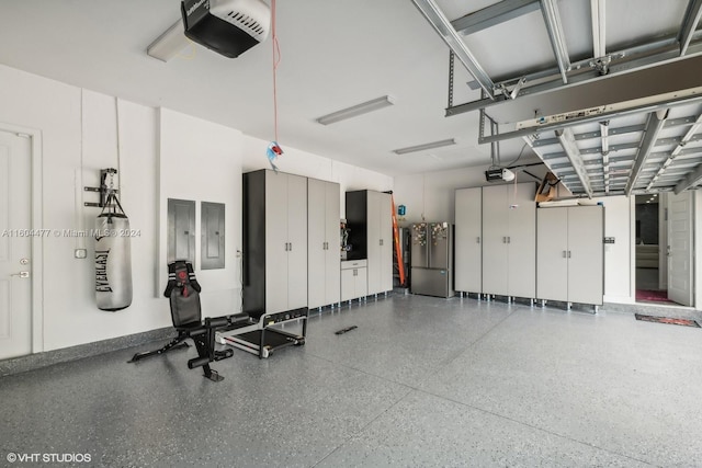 garage with stainless steel fridge, electric panel, and a garage door opener