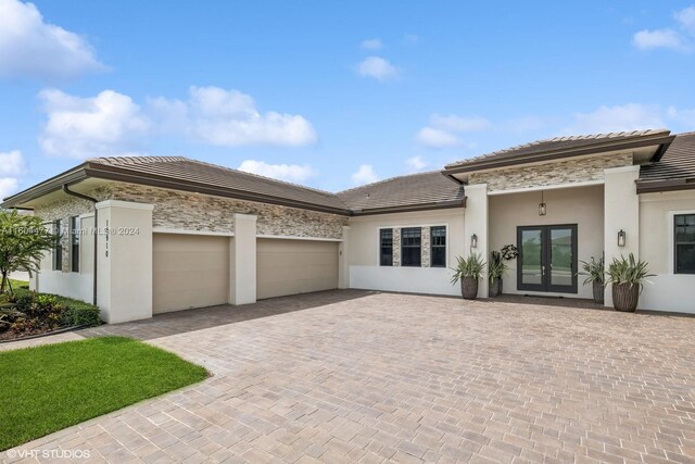 view of front of home featuring french doors and a garage